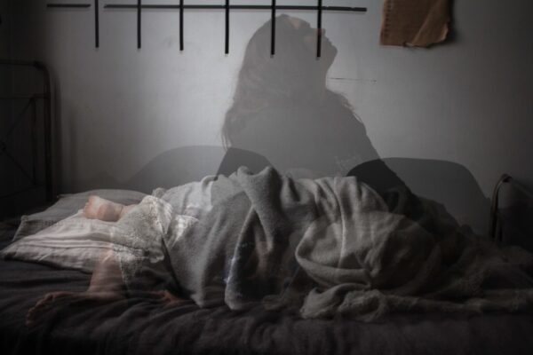 back pain management at home illustrated with a calm living room and highlighted lower back silhouette