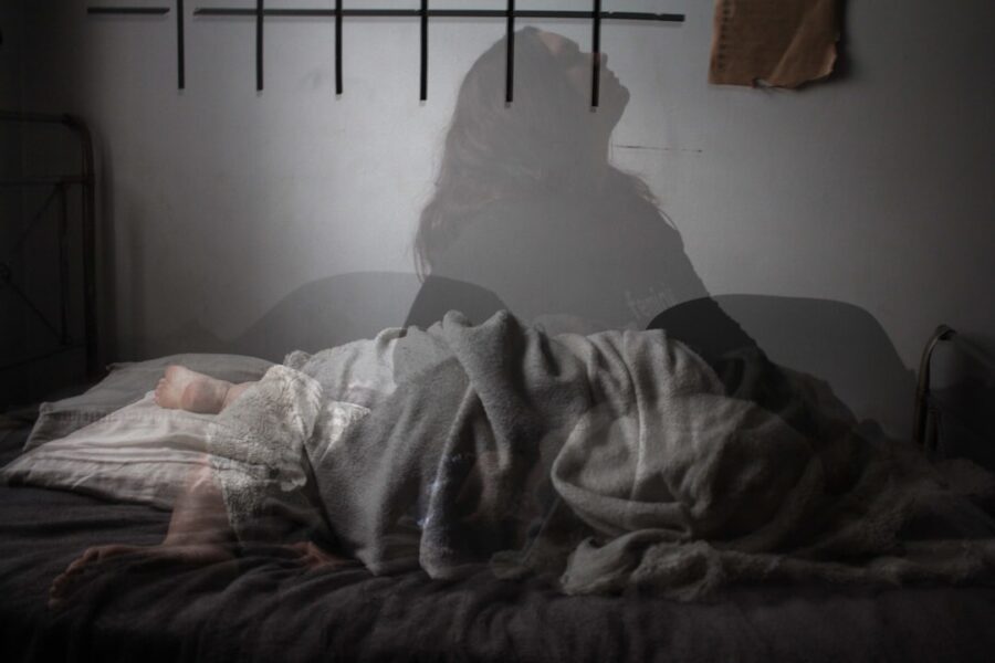 back pain management at home illustrated with a calm living room and highlighted lower back silhouette